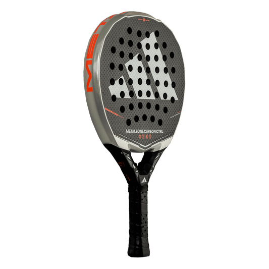 Close angled view of the Adidas Metalbone Carbon CTRL 2026 face with textured carbon and hole pattern, designed for advanced players.