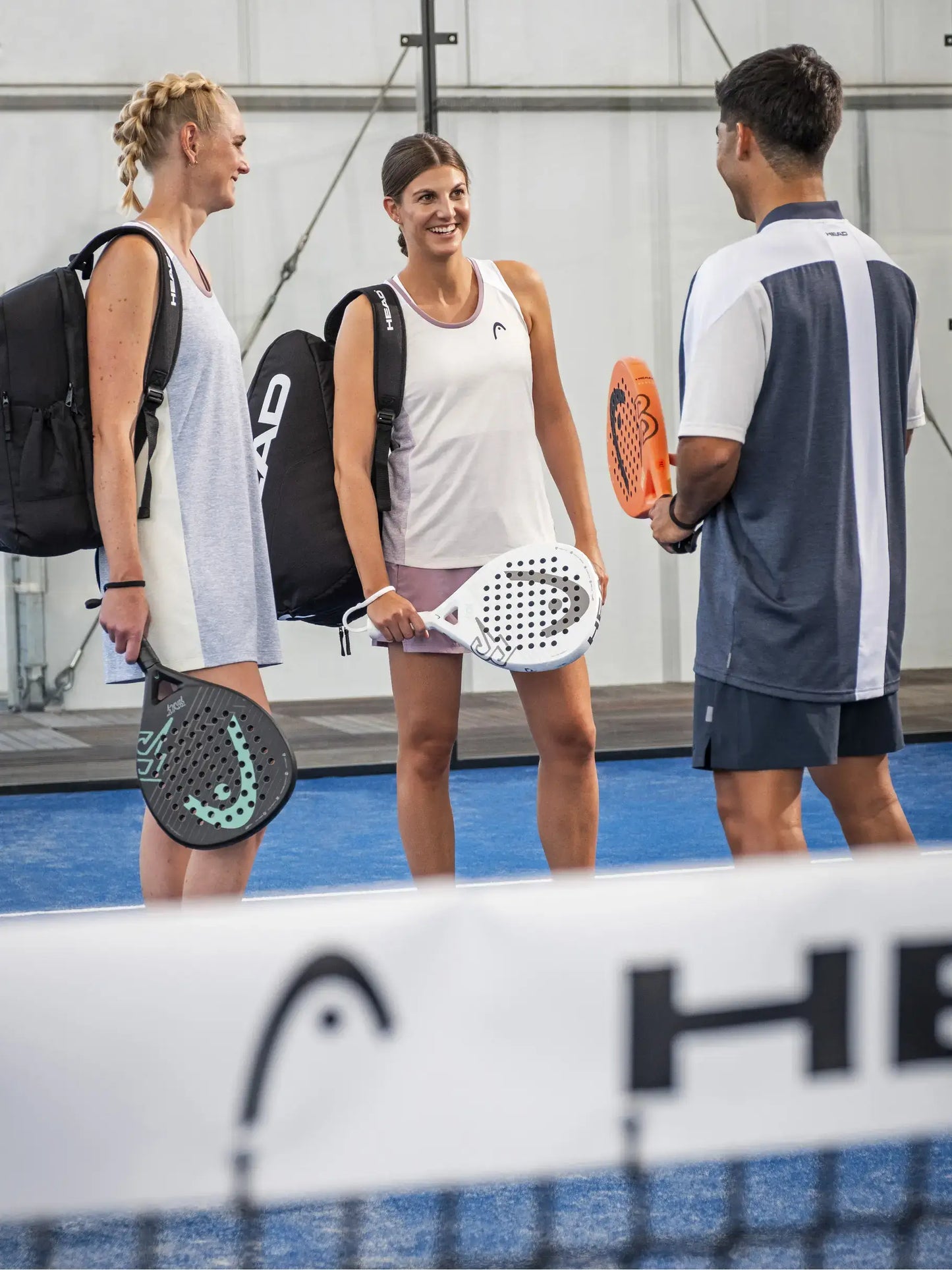 Padel players holding HEAD Bolt 2026 rackets on indoor court, beginner match setting, designed for beginner players