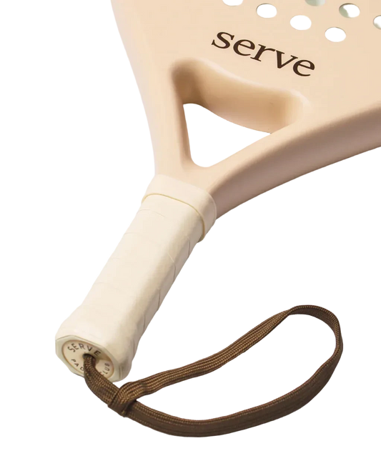 Serve womens padel racket handle close up showing grip and wrist strap detail, designed for women players