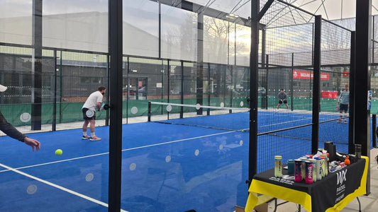 Padel players on a glass walled court with WX Padel equipment, showing what padel is for beginners