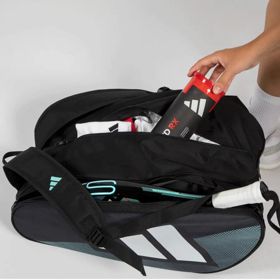 Adidas Control 2026 padel racket bag open showing storage compartment with padel balls and gear