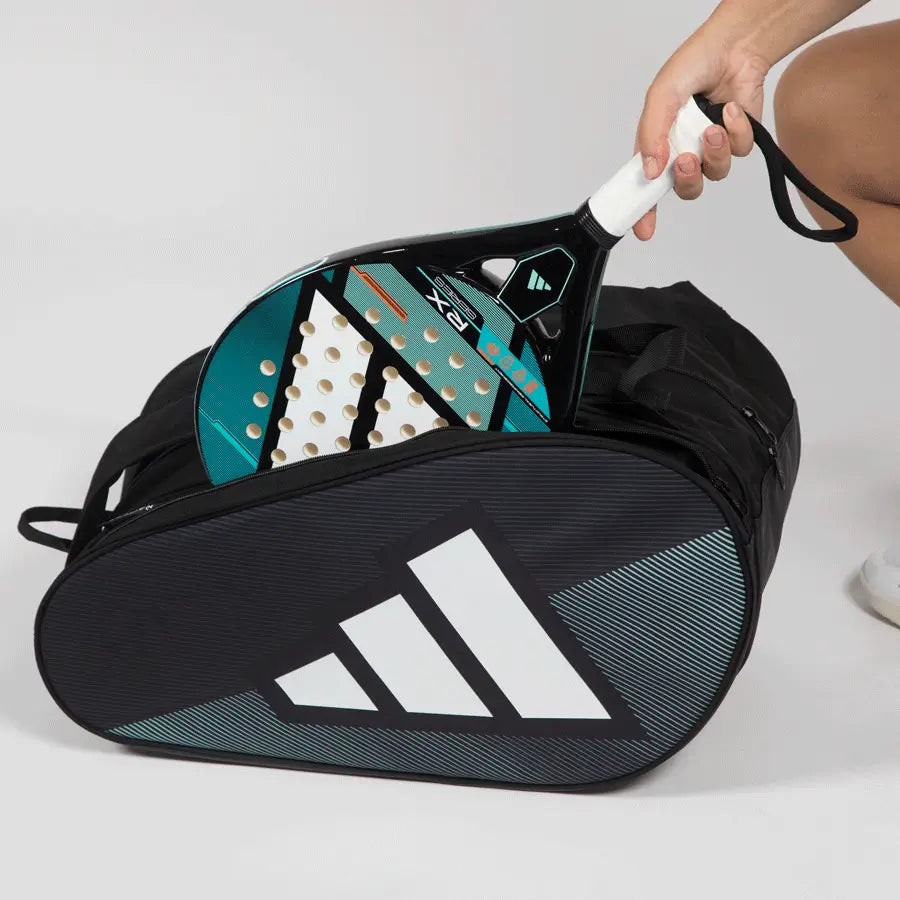 Adidas Control 2026 padel racket bag with racket being placed into side compartment, black compact padel bag