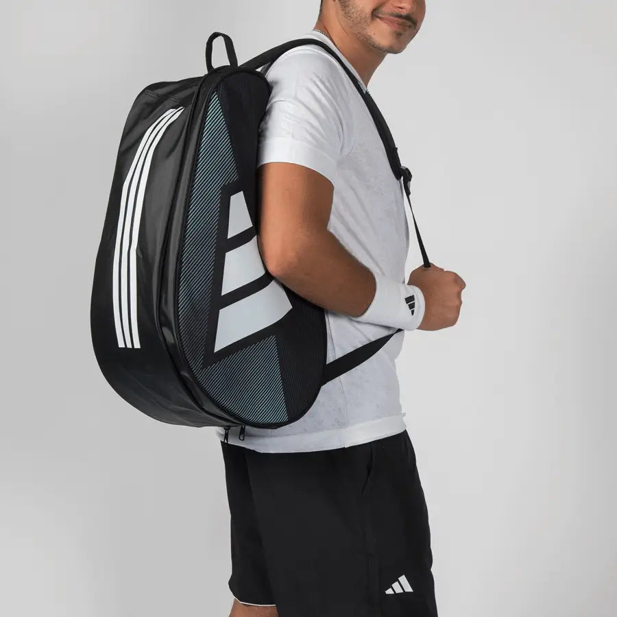 Adidas Control 2026 padel racket bag worn as backpack with padded straps, compact black padel equipment bag