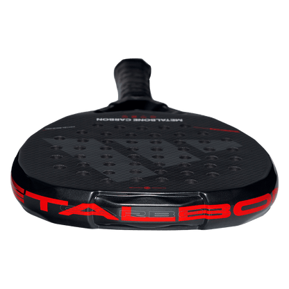 Low angle of the Adidas Metalbone Carbon 2026 racket face with textured carbon surface and hole pattern, designed for advanced players.