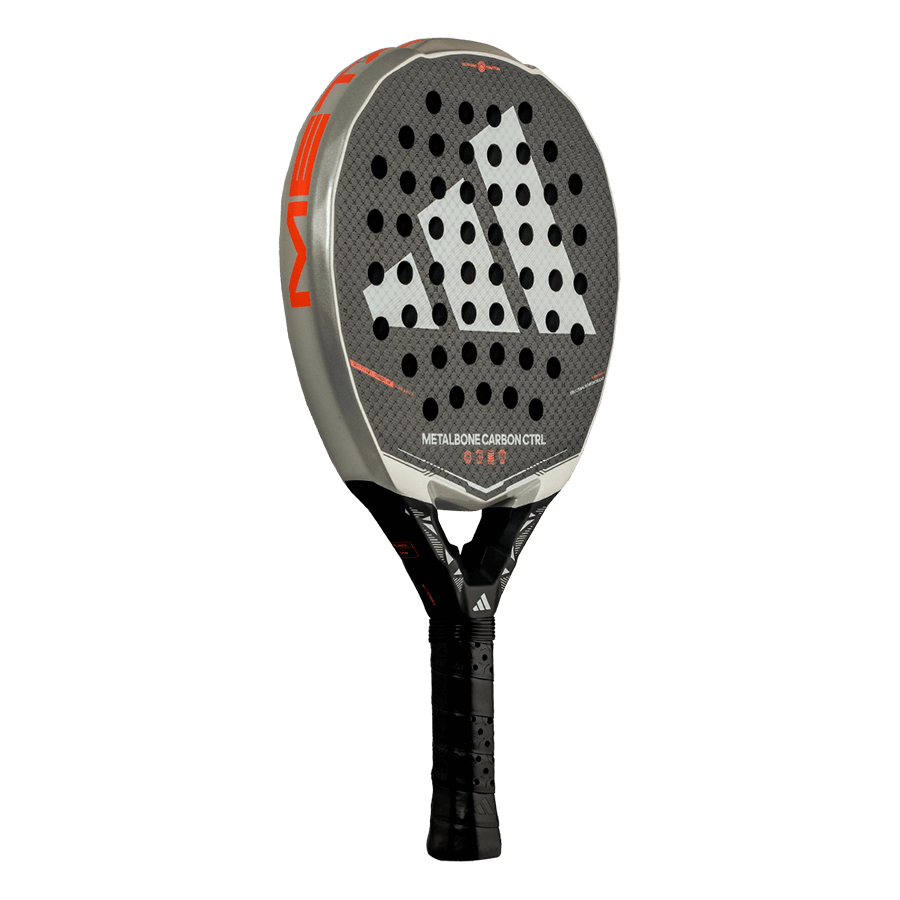 Close angled view of the Adidas Metalbone Carbon CTRL 2026 face with textured carbon and hole pattern, designed for advanced players.