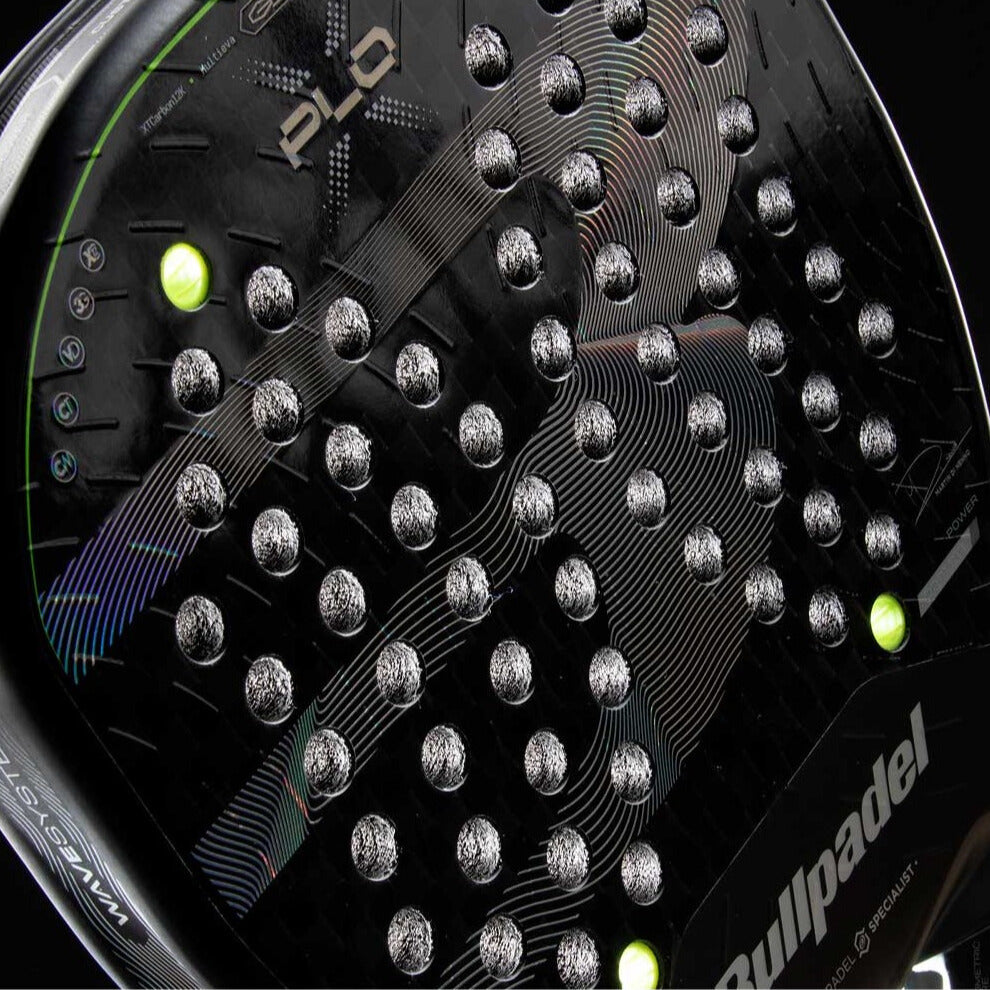 Close-up of the Bullpadel Xplo 26 2026 padel racket surface showing the carbon texture, hole pattern and neon accents, designed for advanced players.