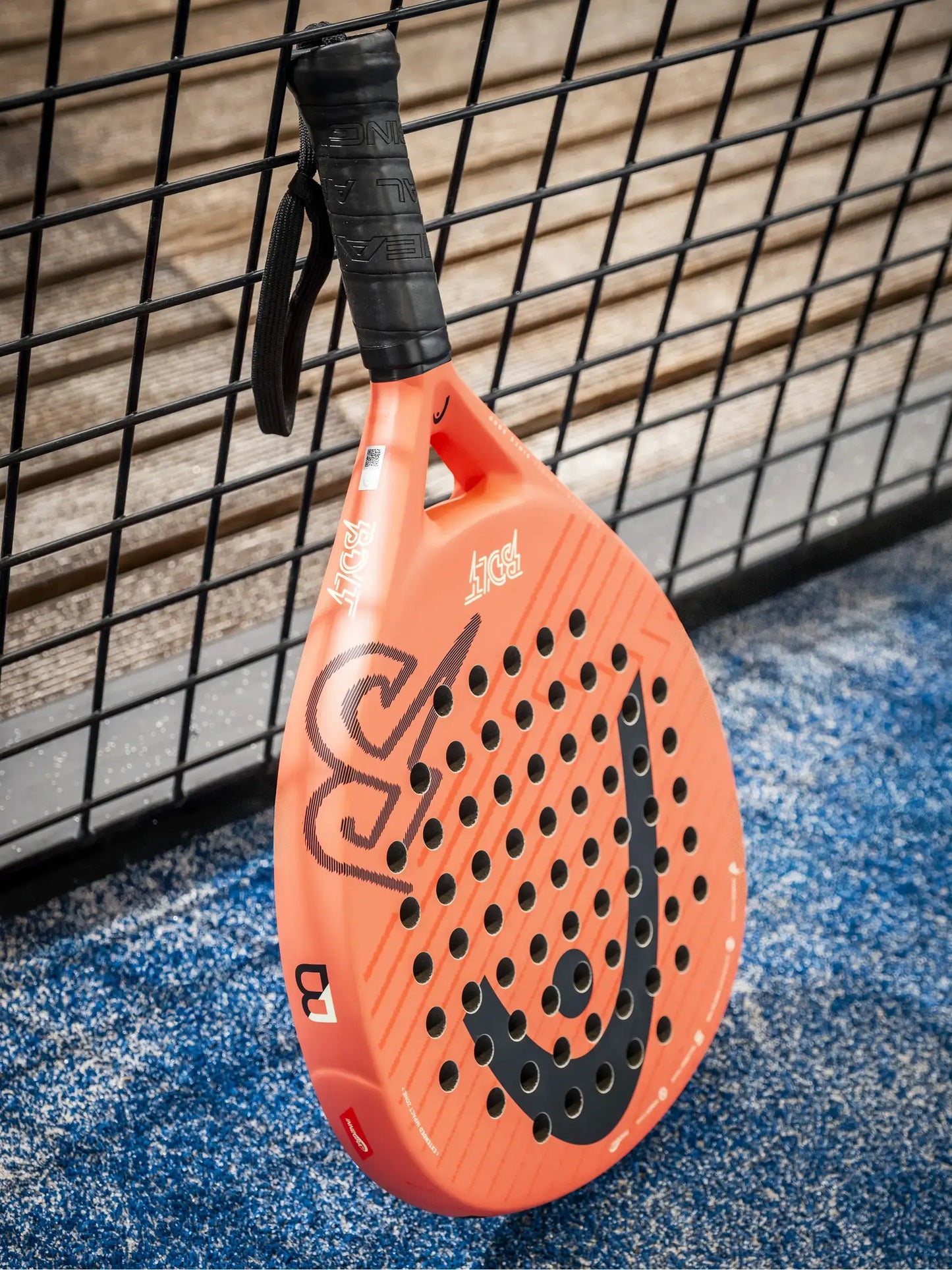 HEAD Bolt 2026 padel racket angled on blue court surface near fence, designed for beginner players