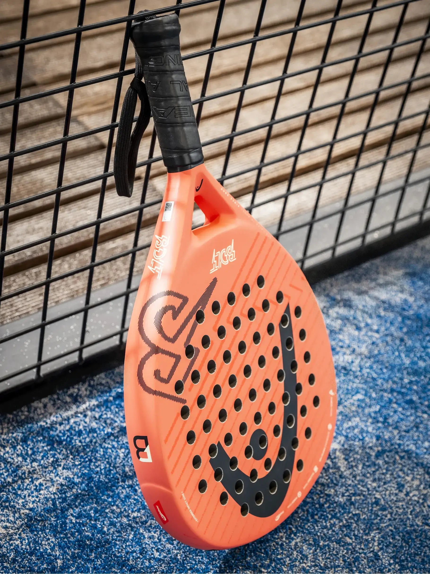 HEAD Bolt 2026 padel racket angled on blue court surface near fence, designed for beginner players