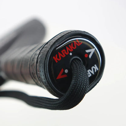 Close-up of Karakal FF PRO butt cap with black X-Air grip and wrist strap, designed for advanced players