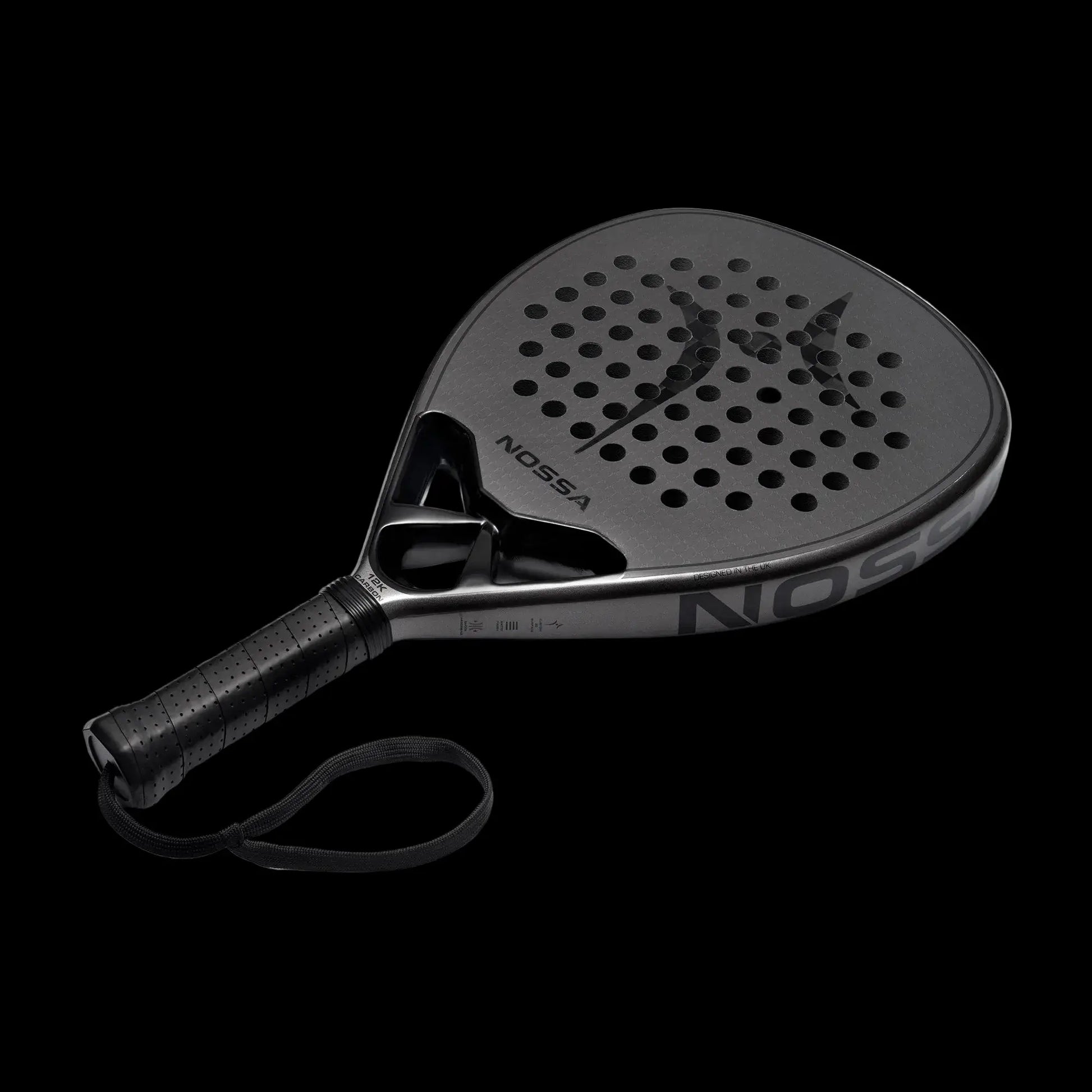 Nossa padel racket angled view in dark grey showing carbon face detailing modern shape and control focused design