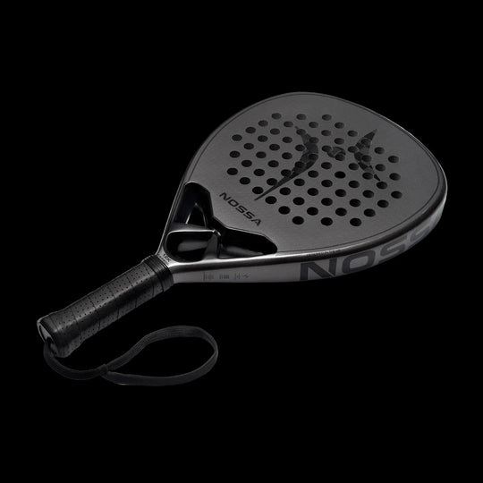 Nossa padel racket angled view in dark grey showing carbon face detailing modern shape and control focused design