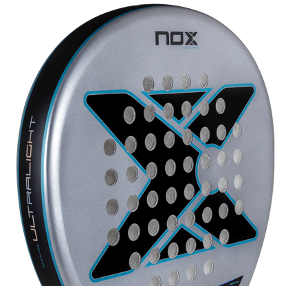Close up of Nox AT10 Genius Ultralight padel racket face highlighting lightweight materials and hole pattern, designed for beginner players