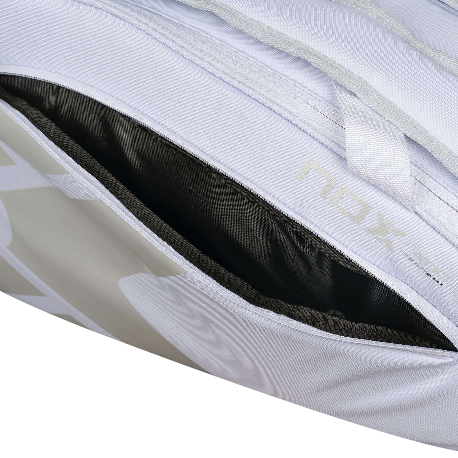 Nox AT10 Team white padel bag thermal compartment close up showing black lined racket storage, designed for all level players