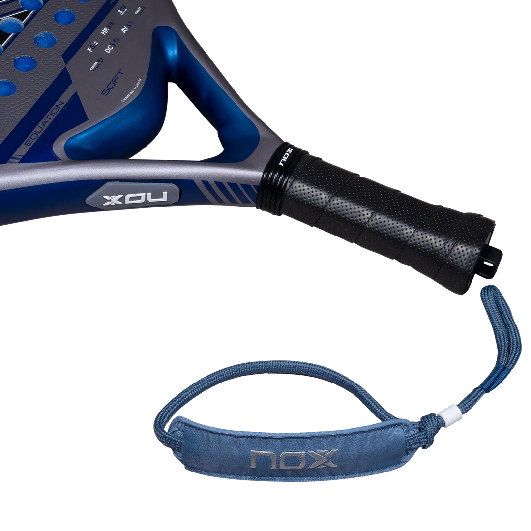 Nox Equation Soft Advanced 2027 padel racket handle with black perforated grip, blue wrist strap and blue throat