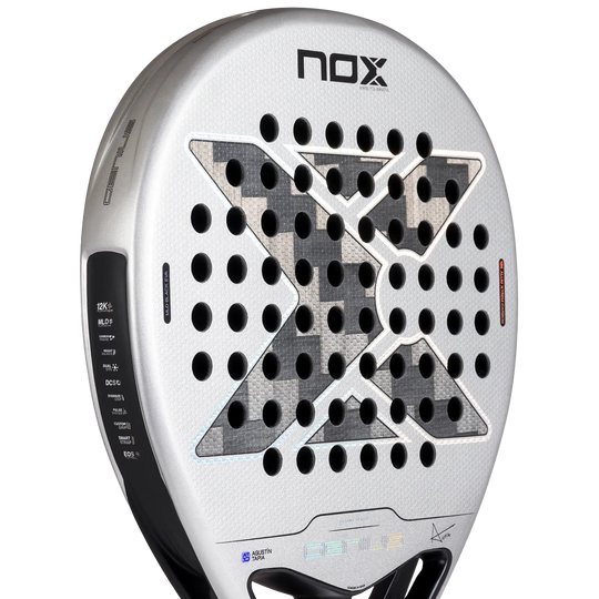 Close-up of NOX Genius 12K Alum XTREM 2027 racket face showing the 12K carbon weave, black X design and drilled holes