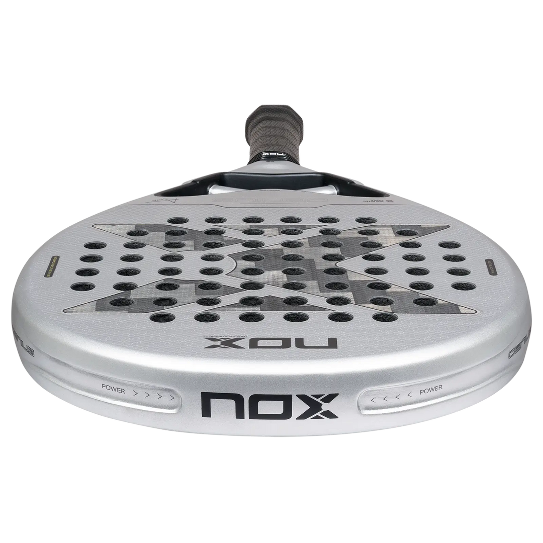 Low-angle close-up of NOX Genius 12K Alum XTREM 2027 padel racket showing its silver head, carbon face and frame edge