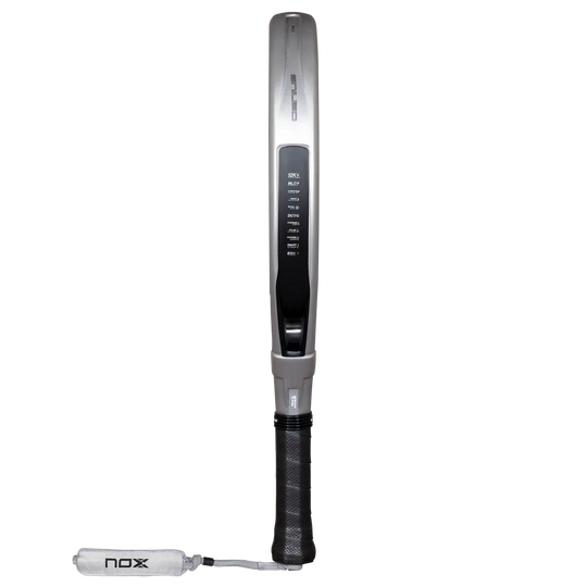 Side profile of the NOX Genius 12K Alum XTREM 2027 padel racket showing its silver frame, black grip and wrist strap