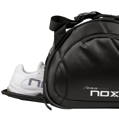 Nox Pro Series black padel racket bag showing ventilated shoe compartment with trainers, designed for all level players