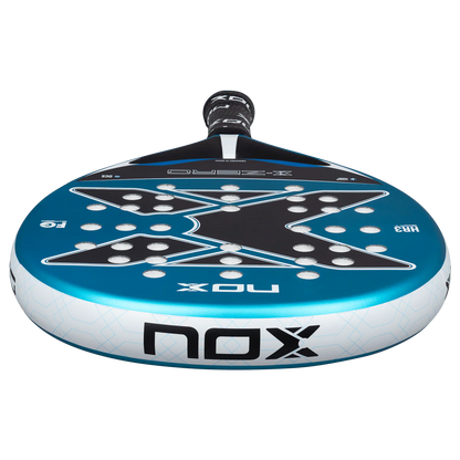 Nox X-Zero Blue 26 padel tennis racket for beginners, close-up low angle showing blue X design and NOX branding on transparent background