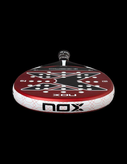 Bottom view of the Nox X-Zero Red 26 padel racket showing red surface white frame and black X design, designed for beginner players.