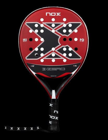 Front view of the Nox X-Zero Red 26 padel racket in red and black with white hole pattern and X-shaped design, designed for beginner players.