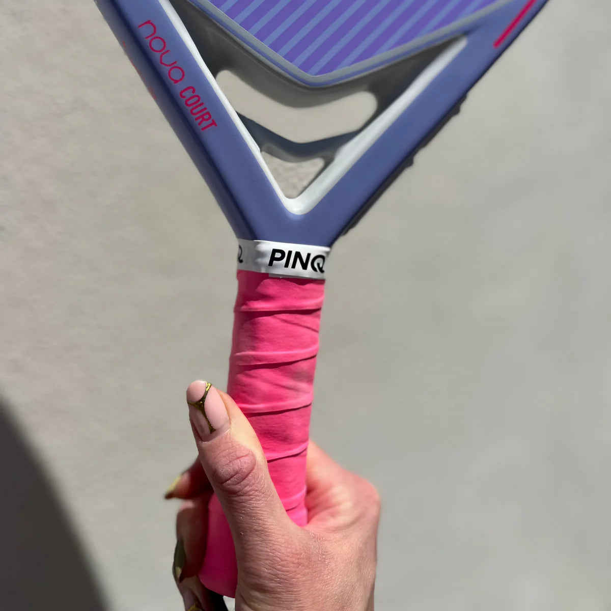 PINQ pink padel overgrip wrapped on racket handle, sweat absorbing grip for secure non slip padel play.