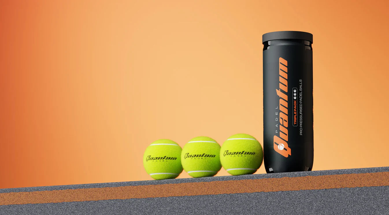 Quantum Pro padel balls with pressurised tube displayed on padel court surface