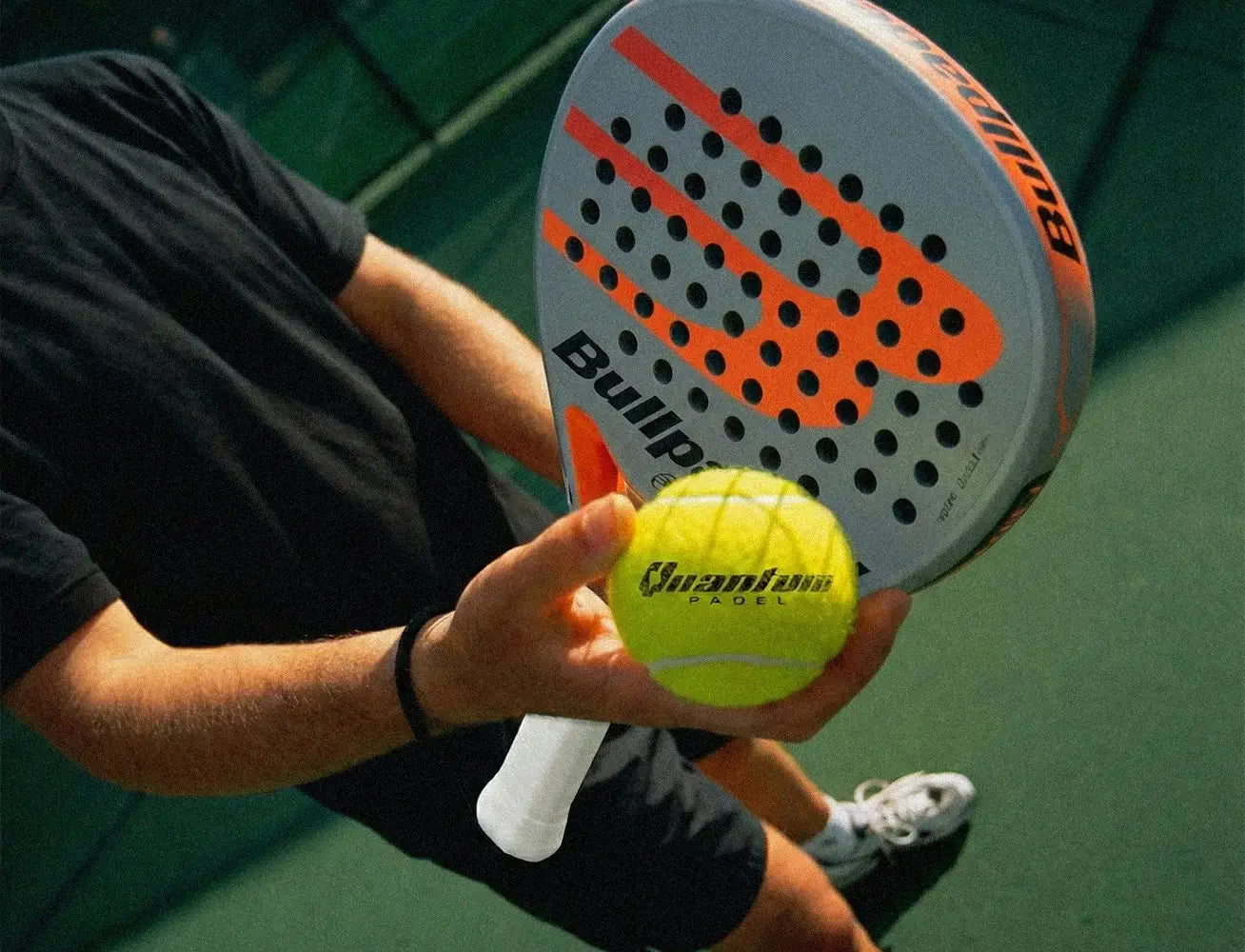 Quantum Pro padel ball close up with padel racket during match play on indoor court