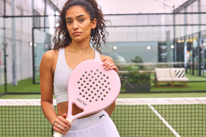 Woman holding Serve womens padel racket at the net on padel court, designed for women players.