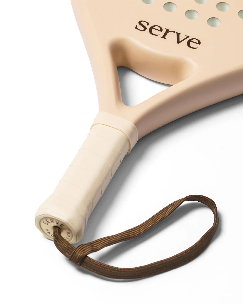 Serve womens padel racket handle close up showing grip and wrist strap detail, designed for women players