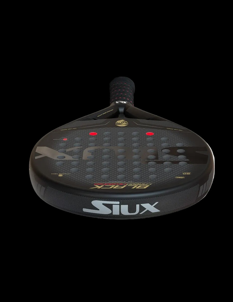 Siux black carbon revolution 3k padel racket low angle view showing full hitting surface.