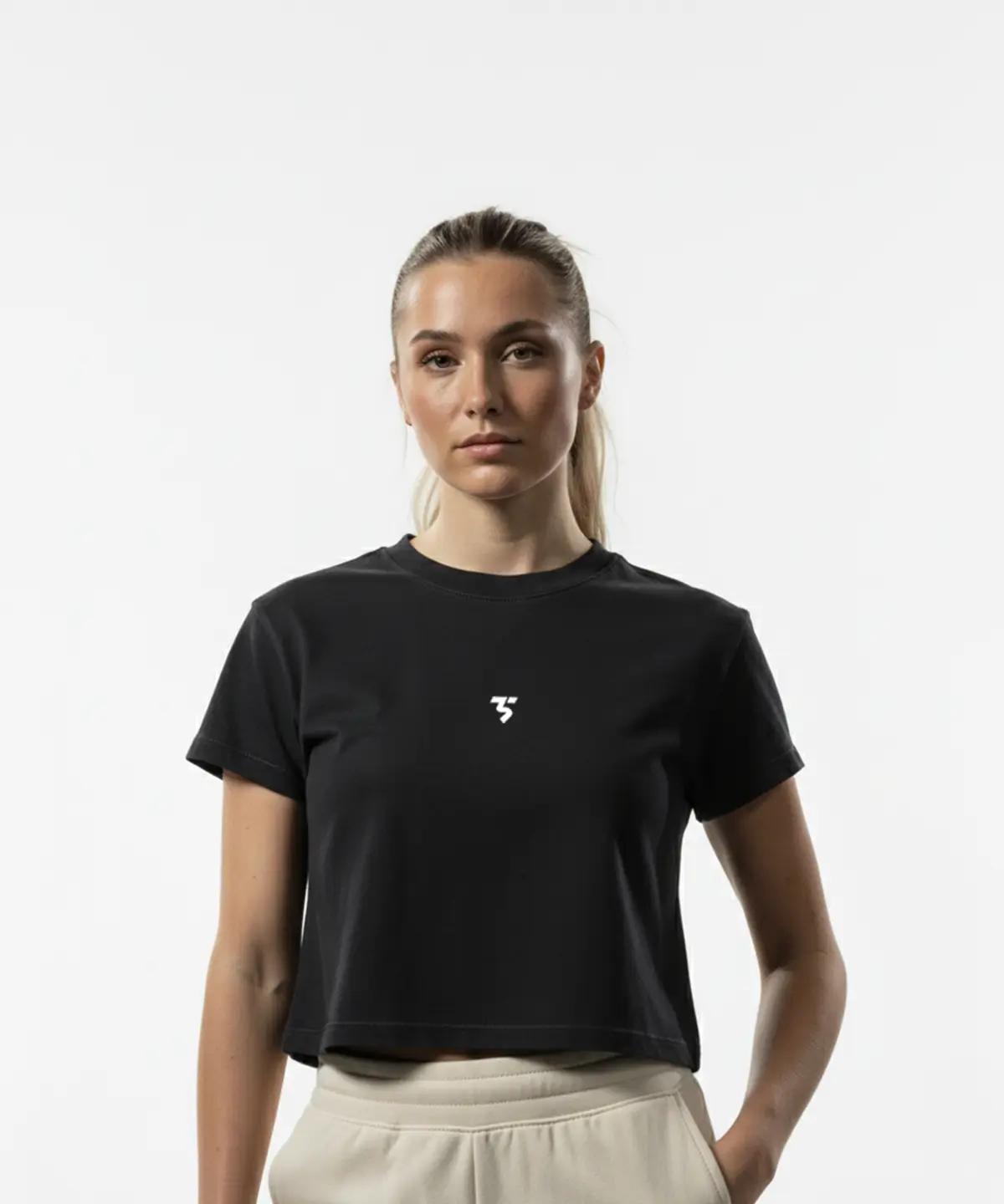 model wearing Third Shot women’s cropped cotton tee in black front view with round neckline, designed for all level players