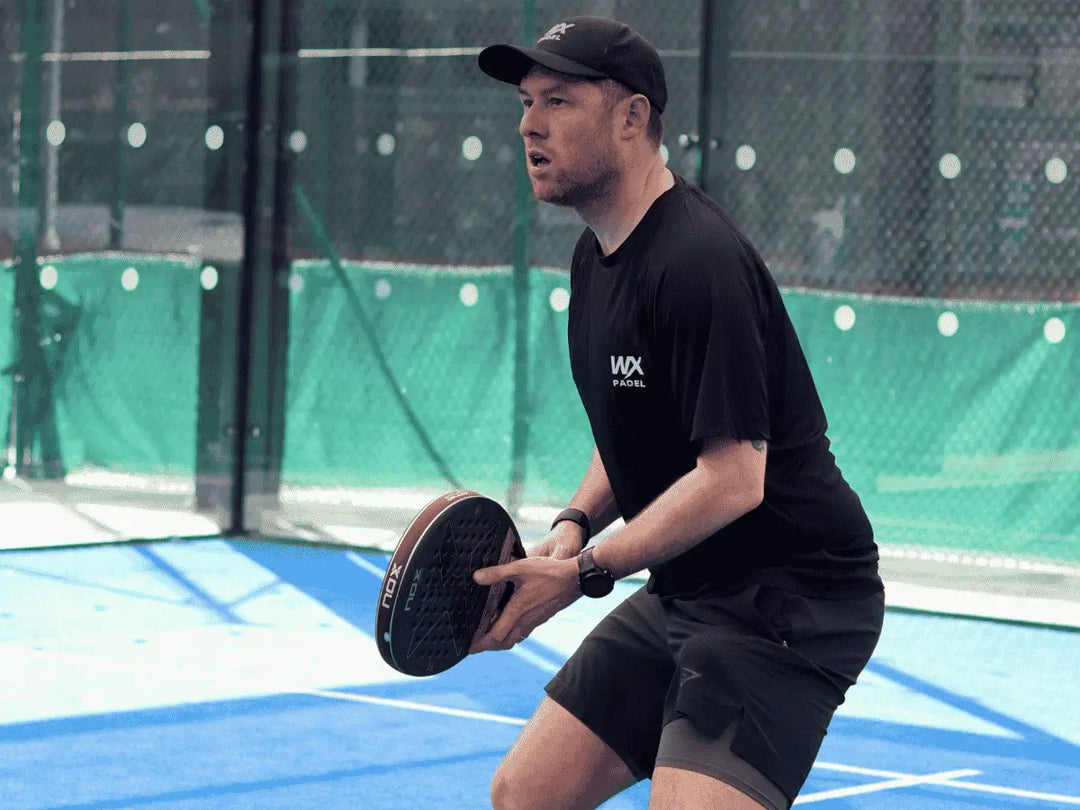 padel player in WX Padel branding on court during a game. 