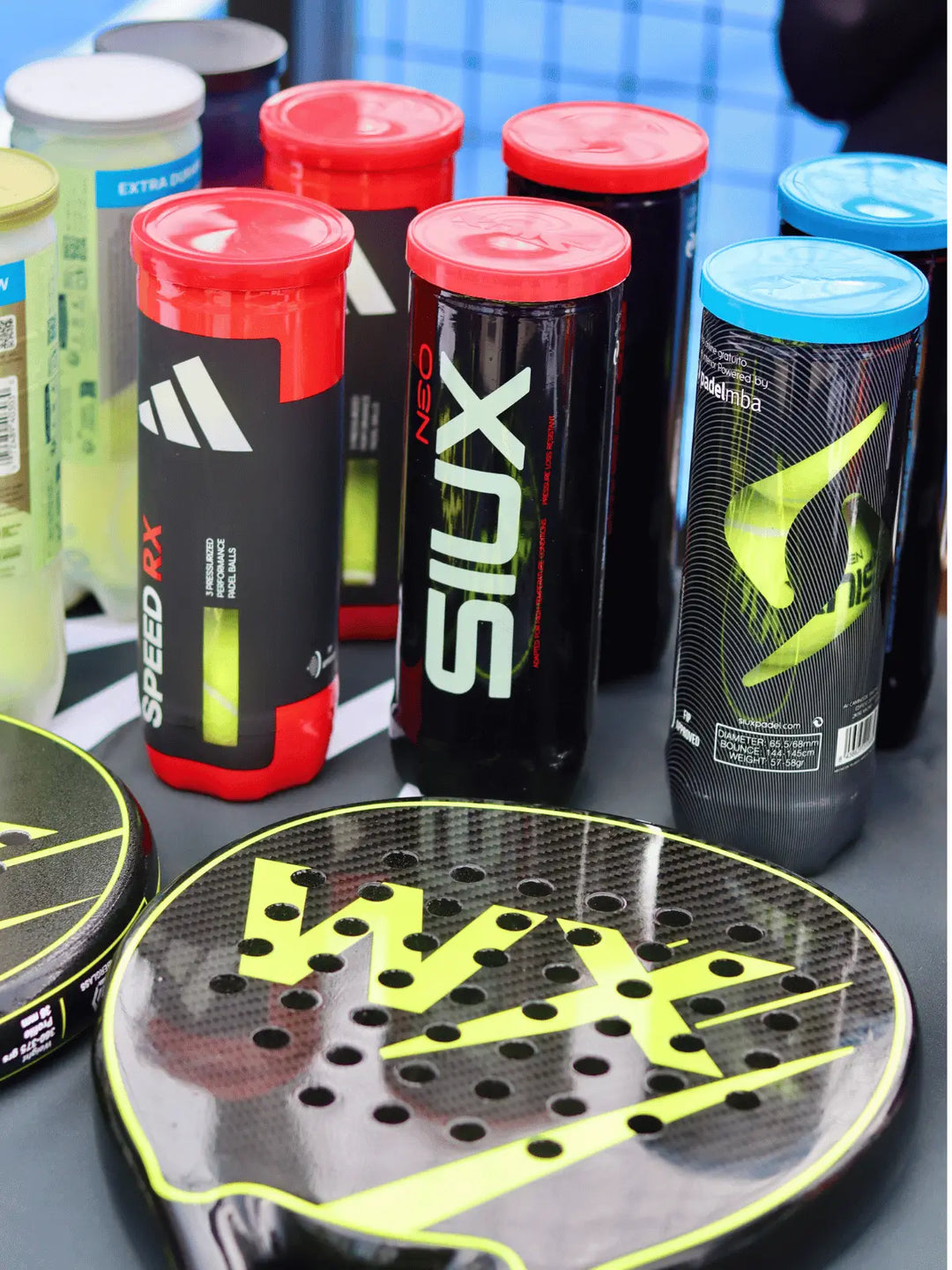 Selection of padel balls and rackets available for WX Padel commercial supply
