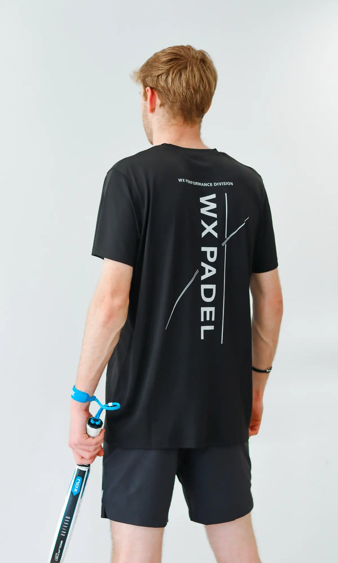 Male player wearing the WX Padel Men’s Performance Division T-Shirt showing the large back print