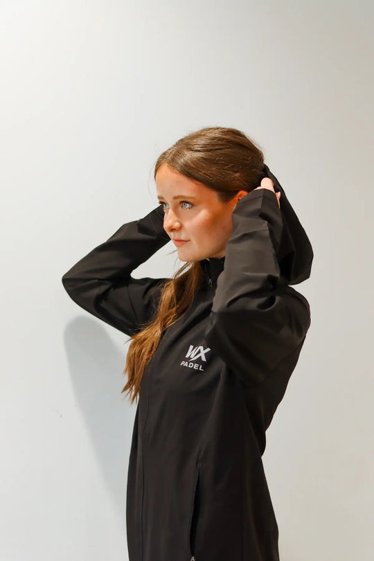 Female player wearing the WX Padel Performance Division Technical Full-Zip Hoodie in black