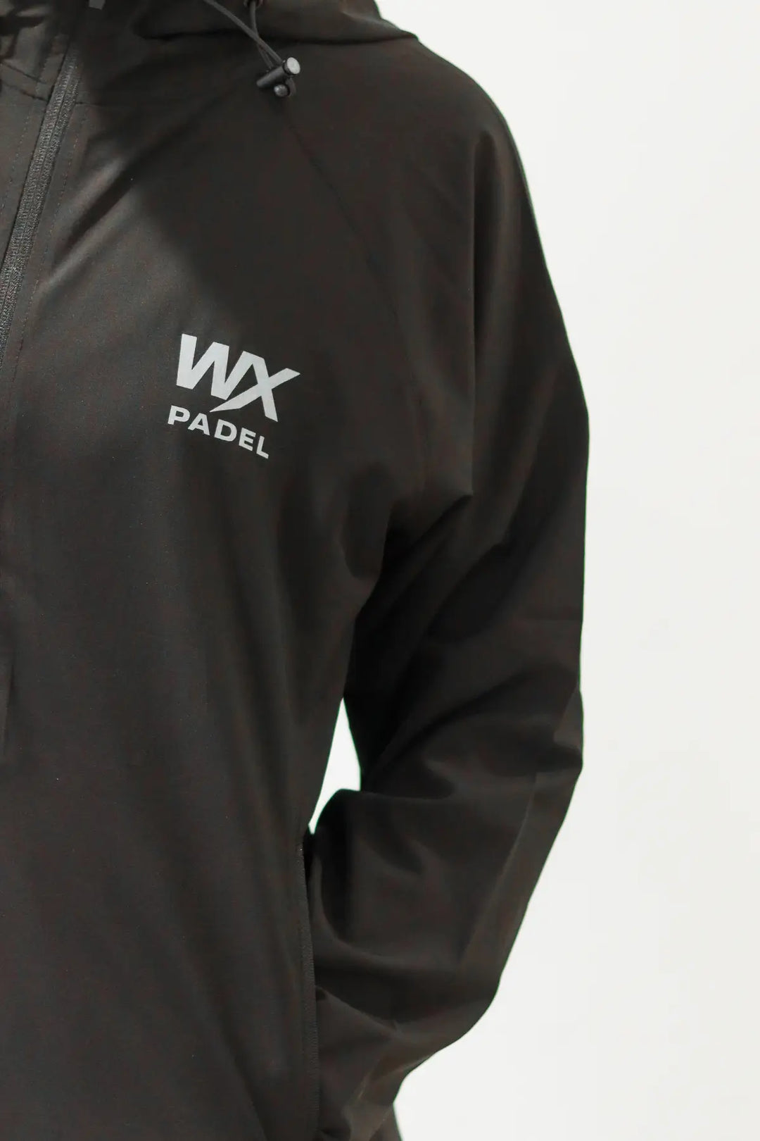 Grey WX Padel chest logo detail on the black Performance Division Technical Full-Zip Hoodie
