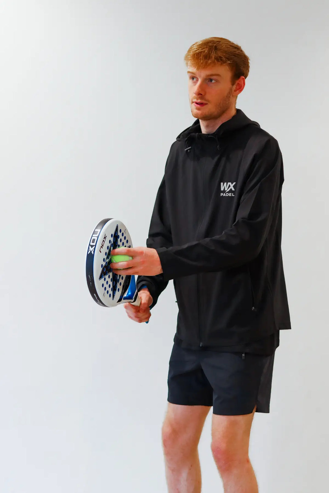 Male player wearing the WX Padel Technical Full-Zip Hoodie in black