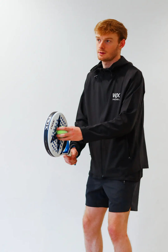Male player wearing the WX Padel Technical Full-Zip Hoodie in black