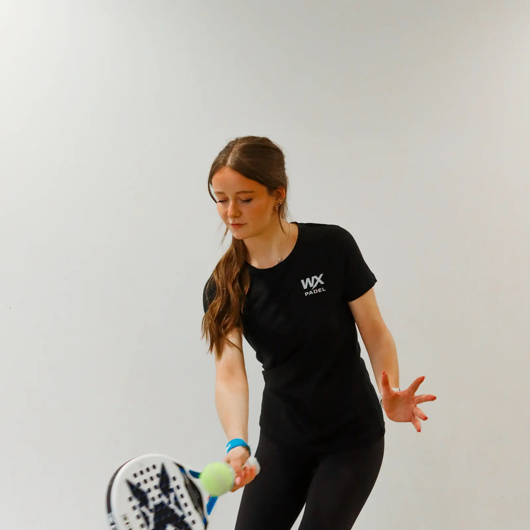 Female player wearing the WX Padel Women’s Performance Division T-Shirt while playing padel