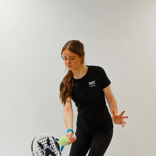 Female player wearing the WX Padel Women’s Performance Division T-Shirt while playing padel